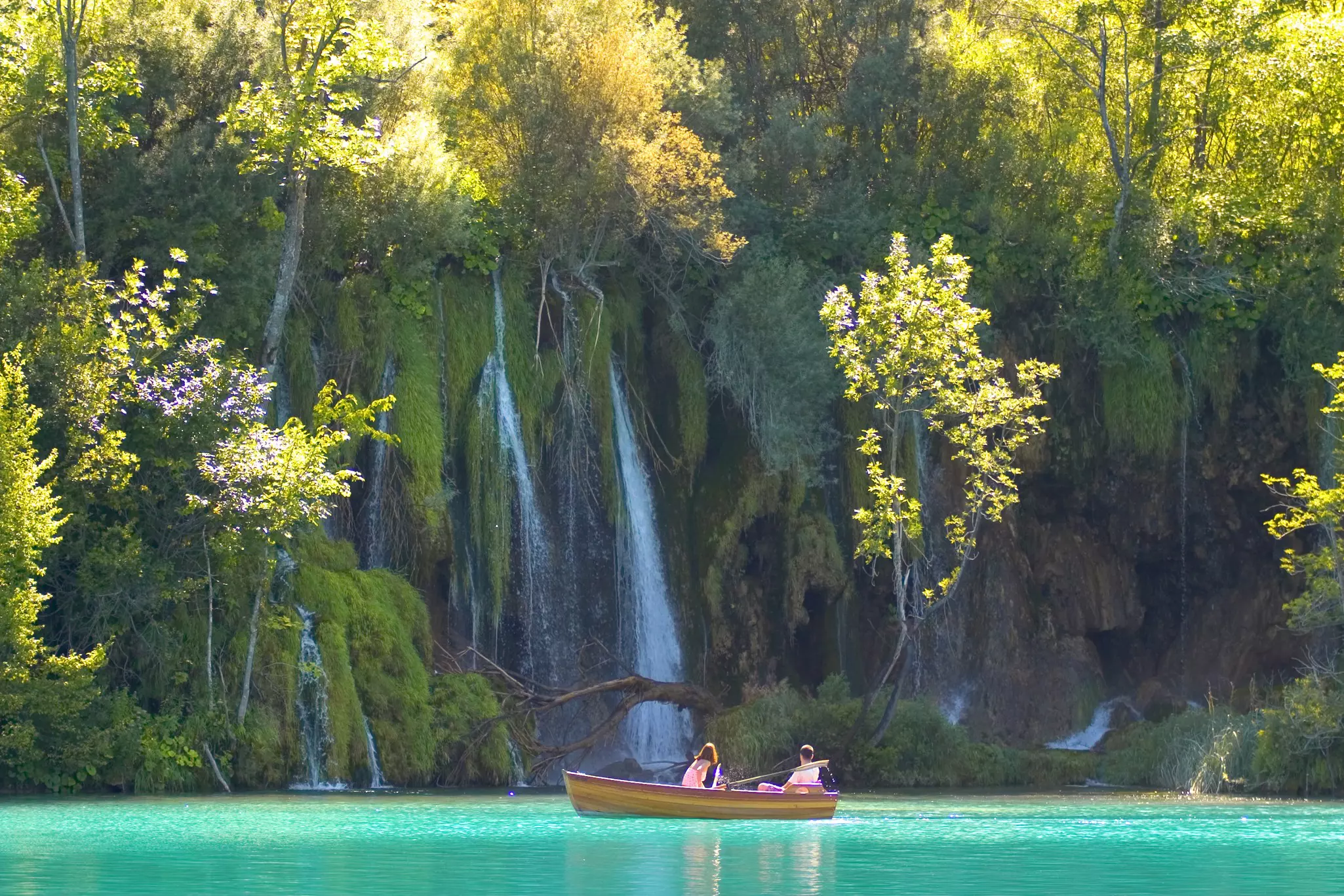Boat near waterfalls, lake Kozjak, Plitvice National Park, Croatia