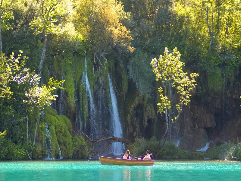 boats near a waterfall