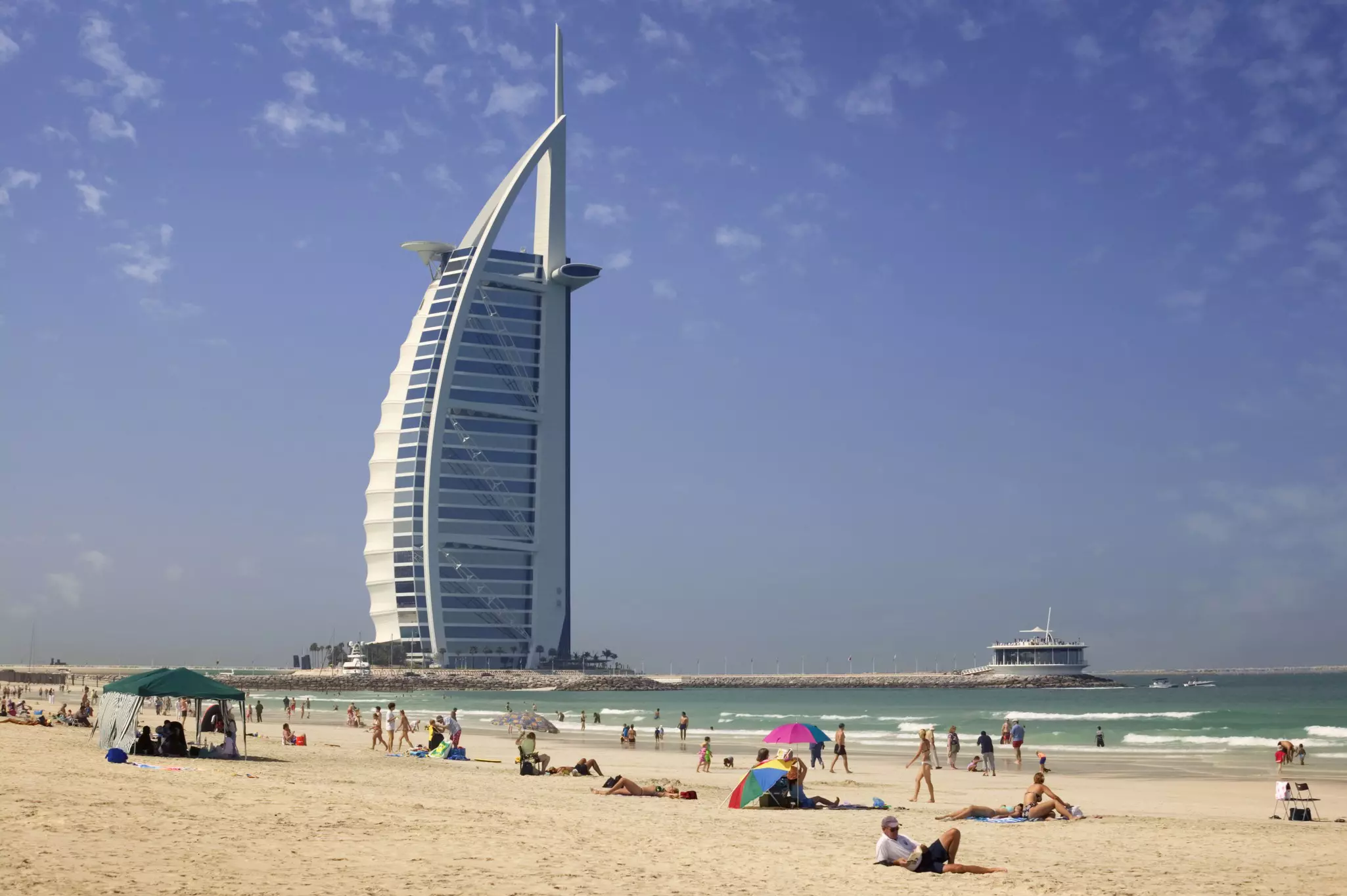 Visitors enjoy the sun at Sunset Beach in Dubai, United Arab Emirates