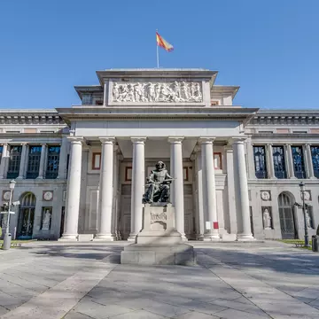The facade of the Prado Museum and the Cervantes statue in Madrid, Spain