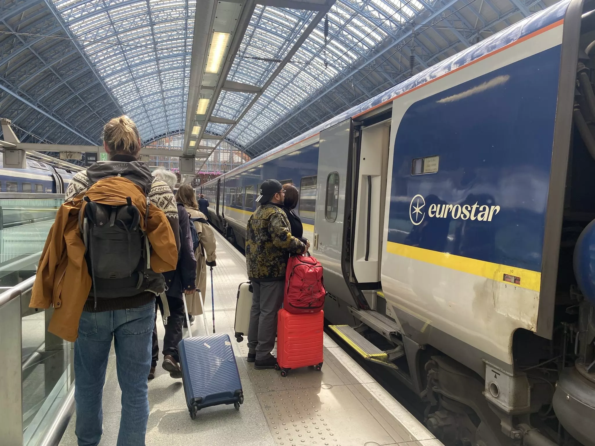 London, England - April 13, 2024: Travelers walk on the platform to board a Eurostar train from London to Paris.