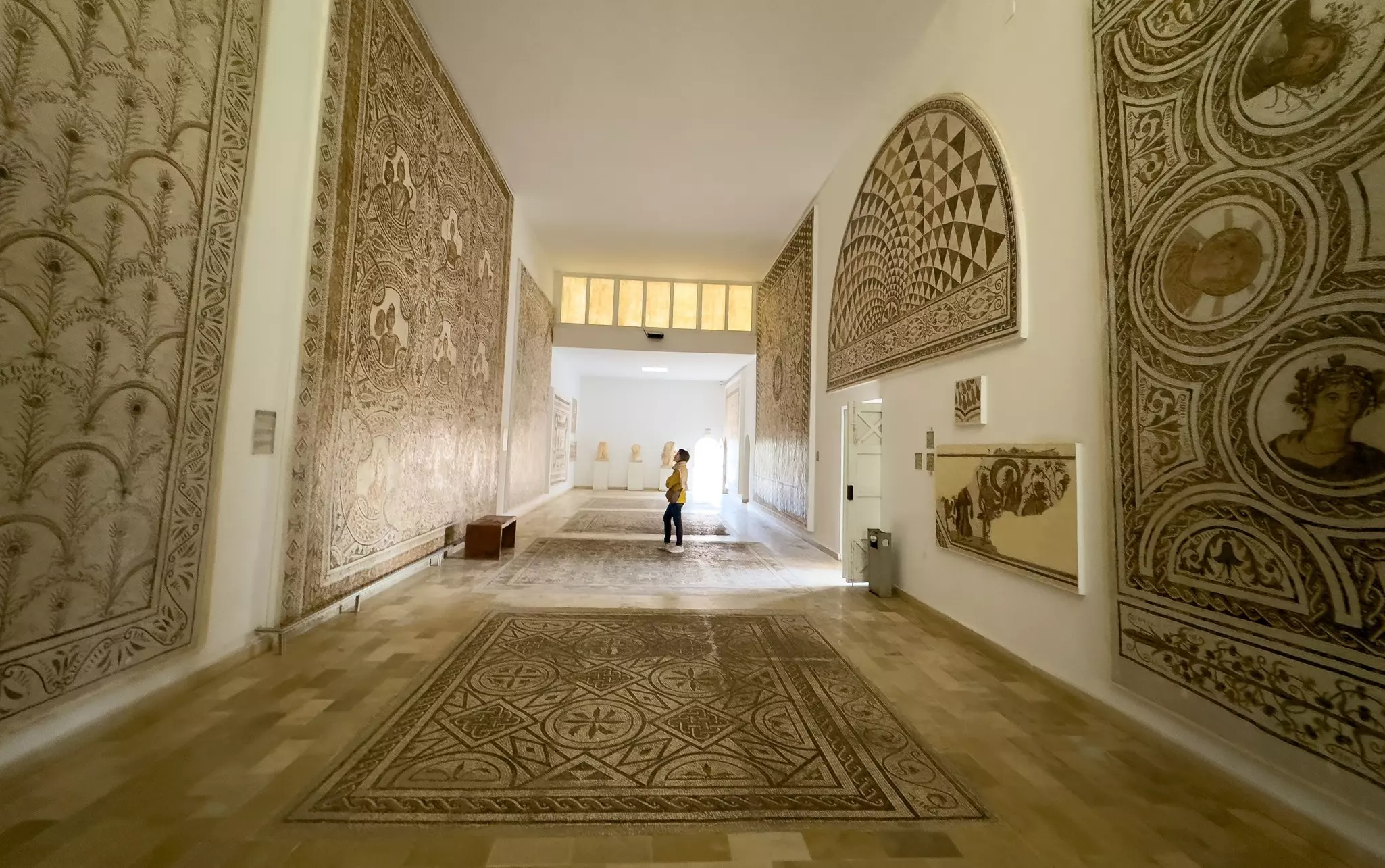 A visitor admires Roman mosaics in the El Jem Archaeological Museum, El Jem, Tunisia.