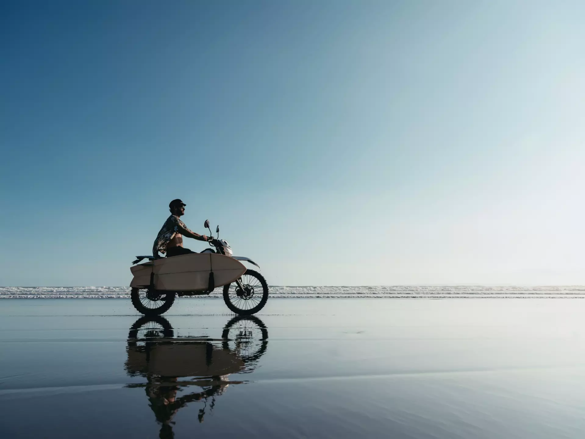 Surfer on a motorcycle riding on an ocean beach in Bali
1287530969
vintage