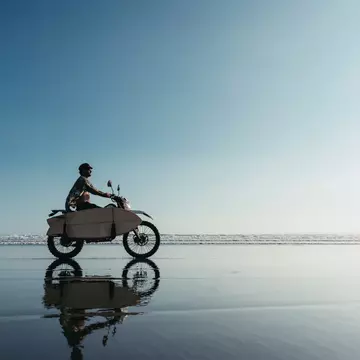 Surfer on a motorcycle riding on an ocean beach in Bali
1287530969
vintage