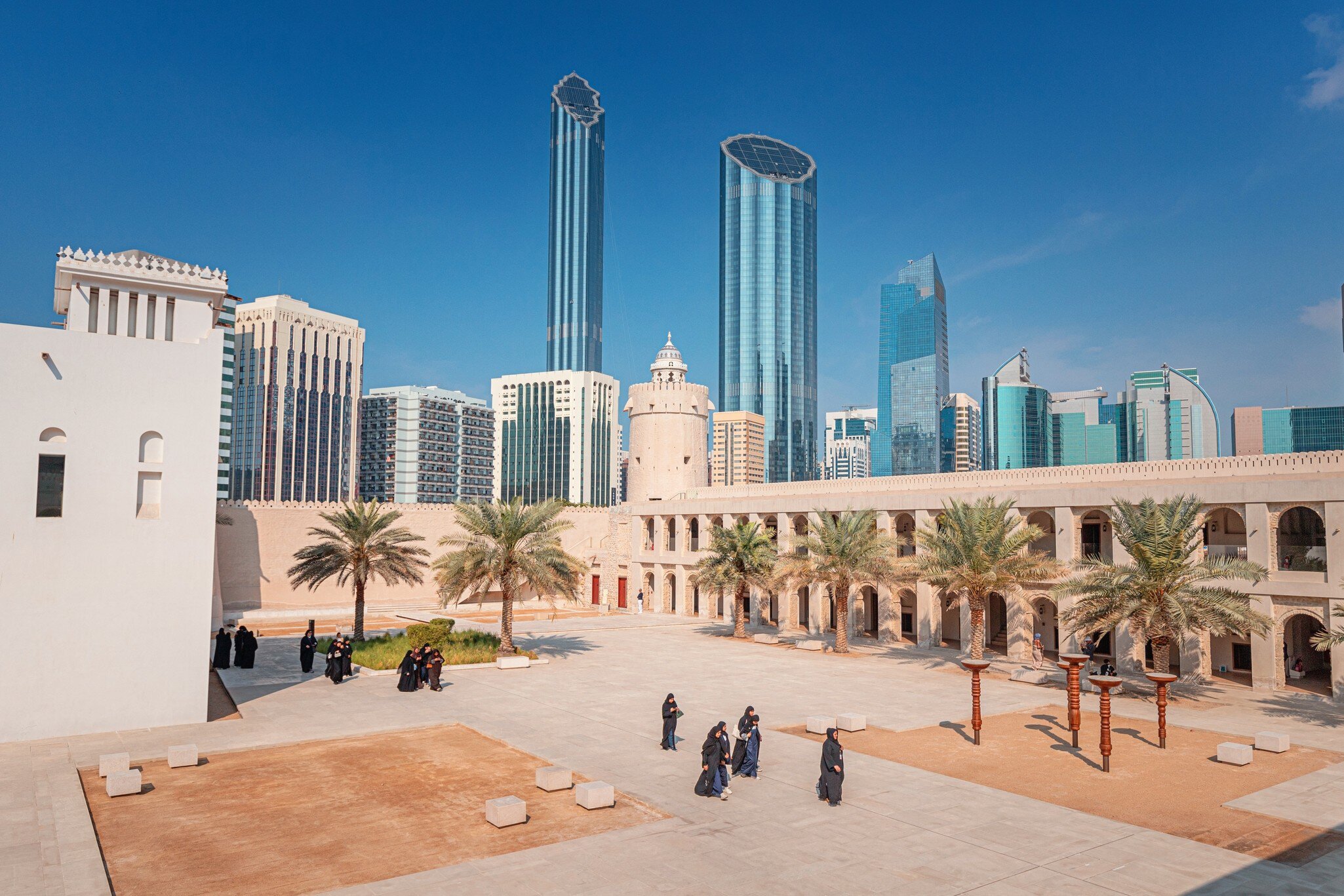 16 January 2025, Abu Dhabi, UAE: Group of tourists walking in the courtyard Qasr Al Hosn Heritage site, with the modern skyline in the background, License Type: media, Download Time: 2026-06-17T14:53:07.000Z, User: pinkjozie64, Editorial: true, purchase_order: 56530 - Guidebooks, job: Global Publishing WIP, client: DUBAI & ABU DHABI 12, other: Jo-anne Riddell