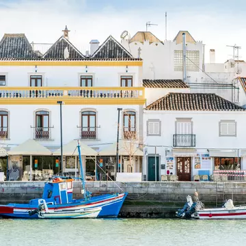 The charming architecture of Tavira with boats on the Gilão River. Sopotnicki/Shutterstock