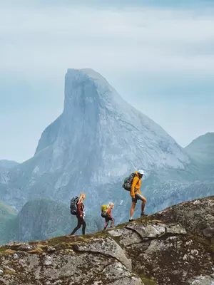 Family hiking in Norway mountains, active vacations with backpack outdoor. Parents and child traveling together healthy lifestyle adventure tour with mother, father and kid trekking in Lofoten islands