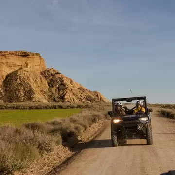 A buggy drives through the dry landscape of Bardenas Reales Nature Preserve. 