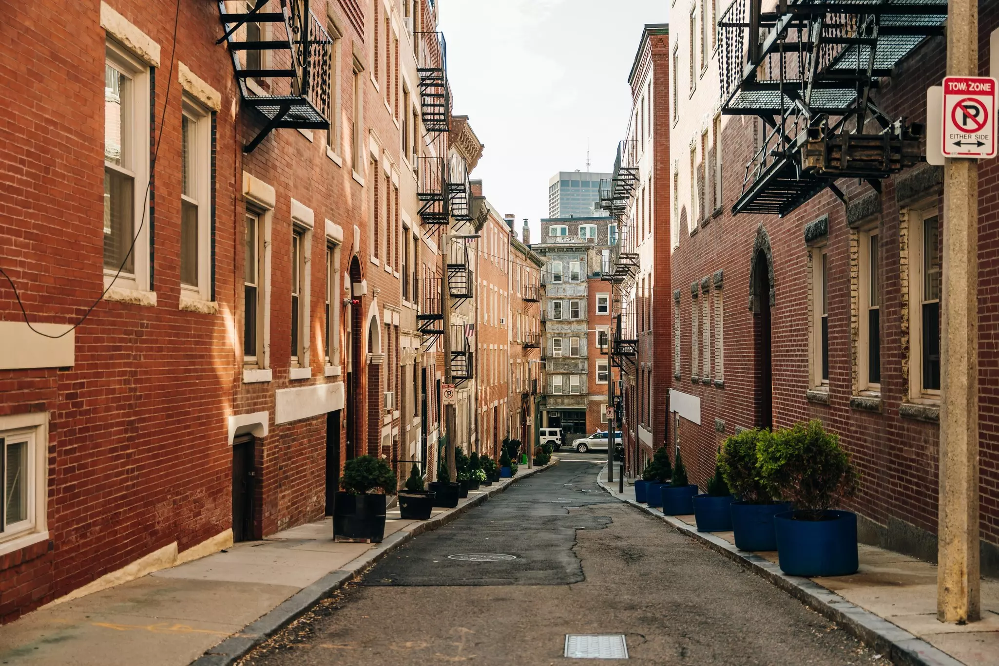 A quaint alleyway with brick buildings in Boston's Little Italy neighborhood