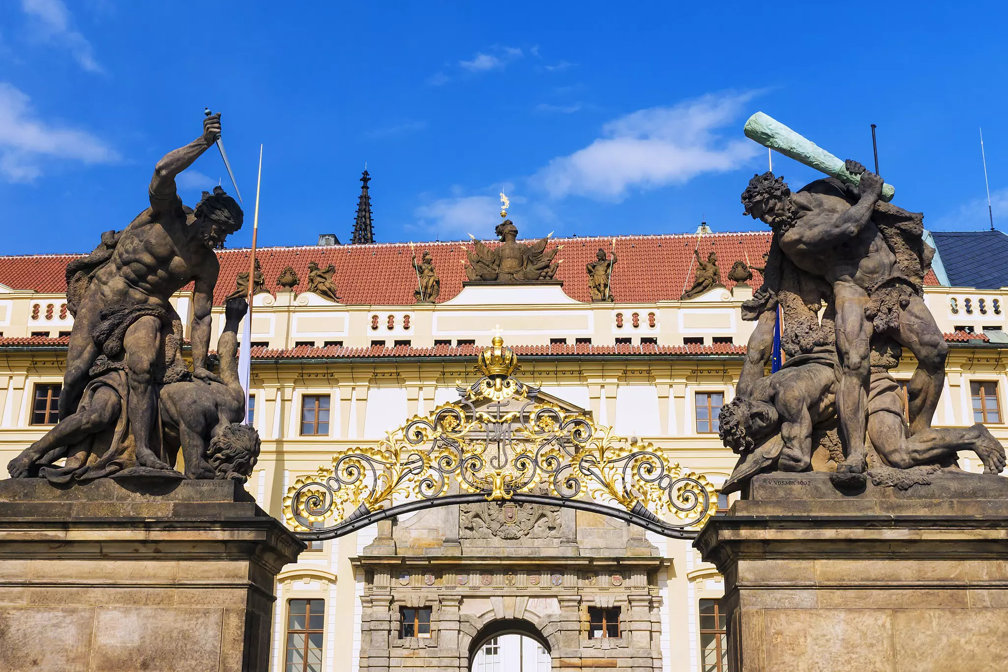 Old statues decorate the western gate to the Prague Castle.
