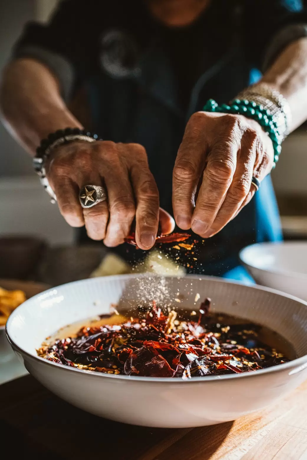 Man seasoning a dish in New Mexico.
