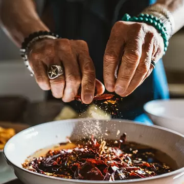 Man seasoning a dish in New Mexico.