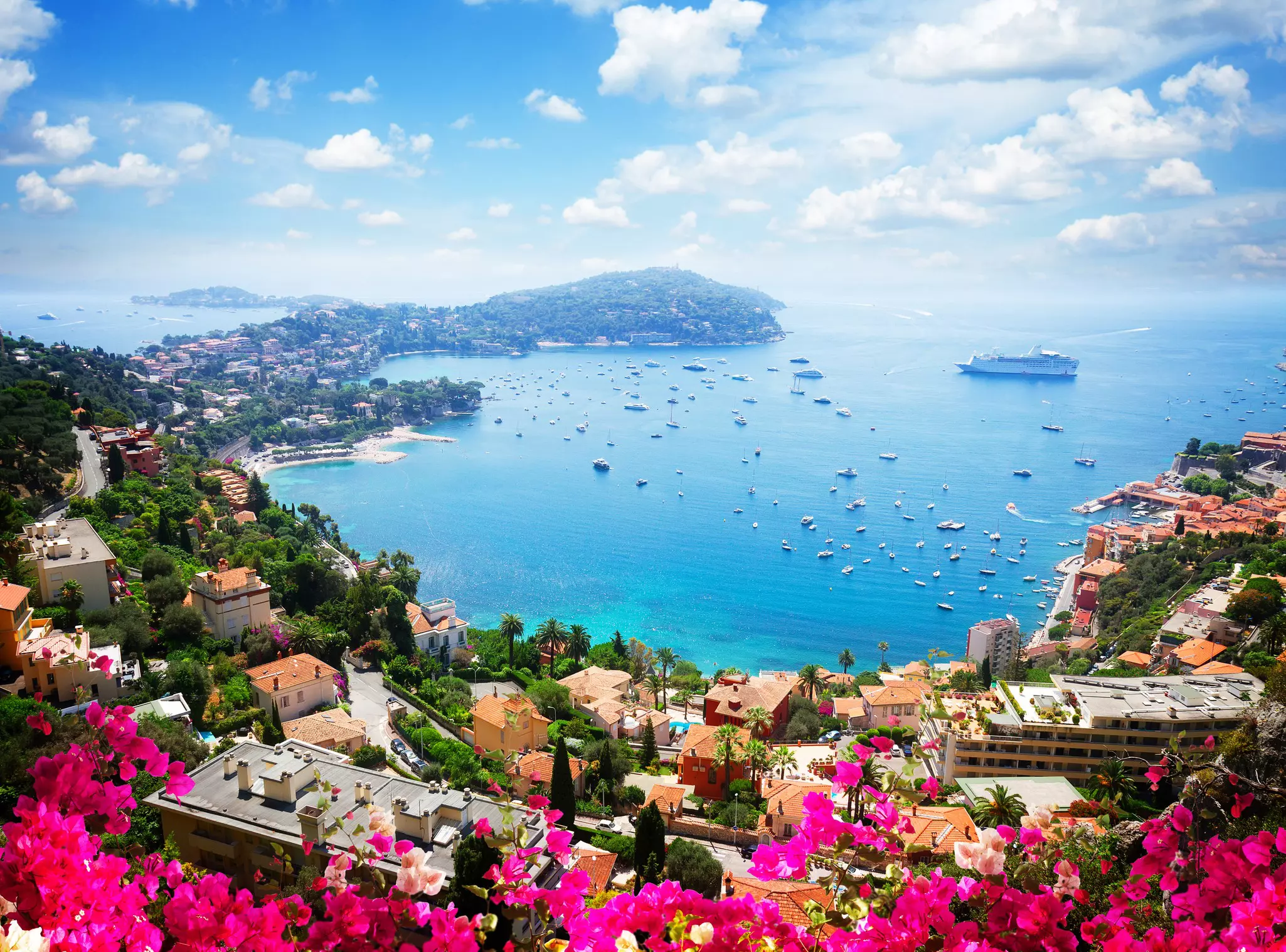 Landscape of riviera coast, turquiose water, flowers and blue sky of cote dAzur at summer day, France.
