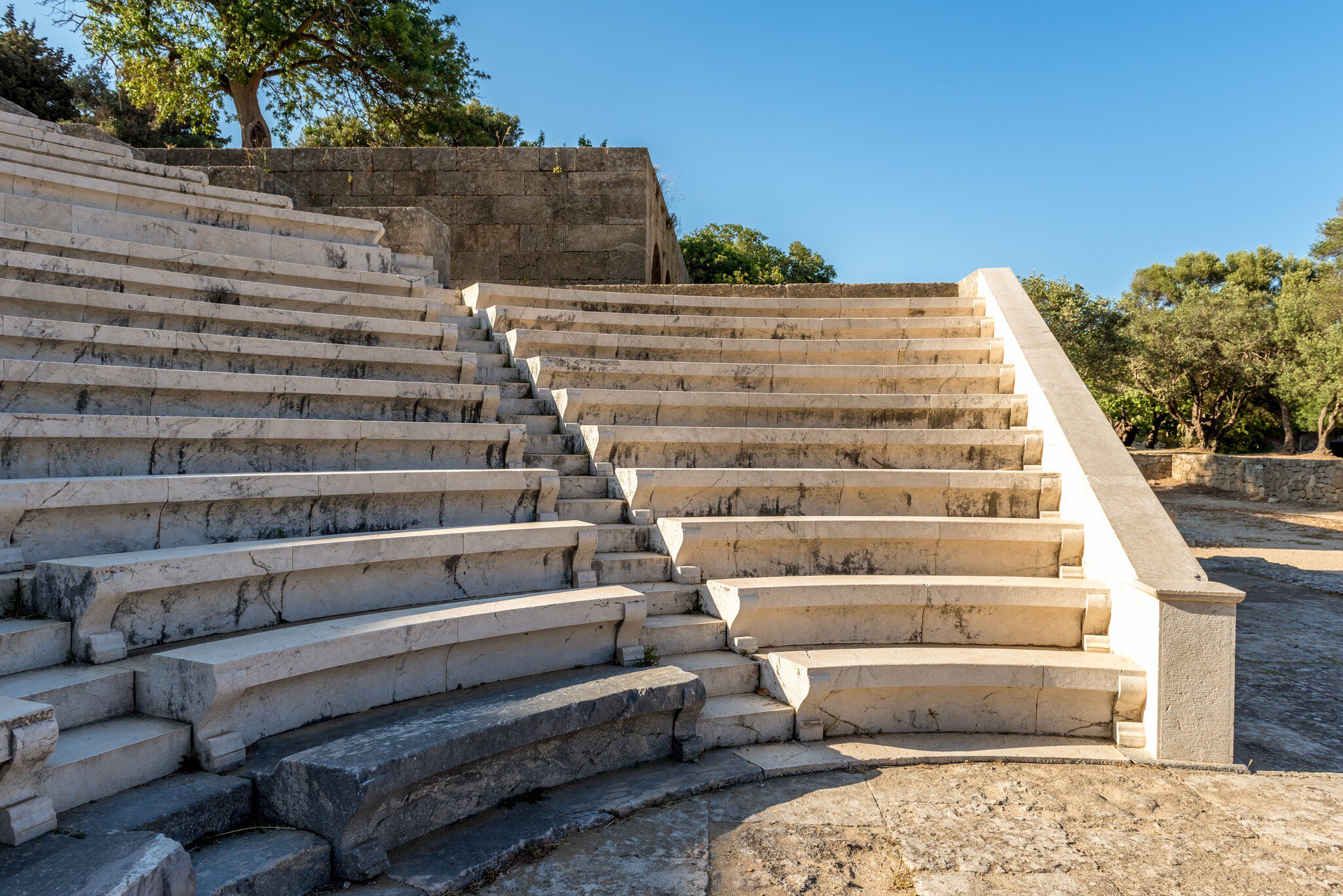View of the marble steps of the ancient theater at the Acropolis of Rhodes in Greece.