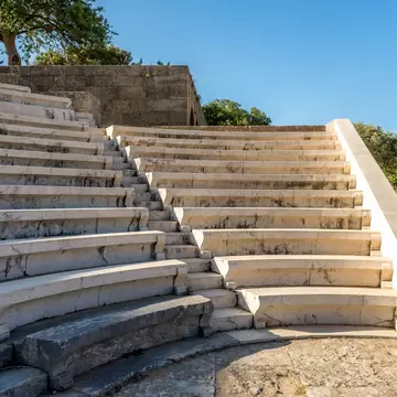 View of the marble steps of the ancient theater at the Acropolis of Rhodes in Greece.