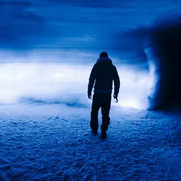 Silhouette of a person inside Langjökull glacier, Iceland.