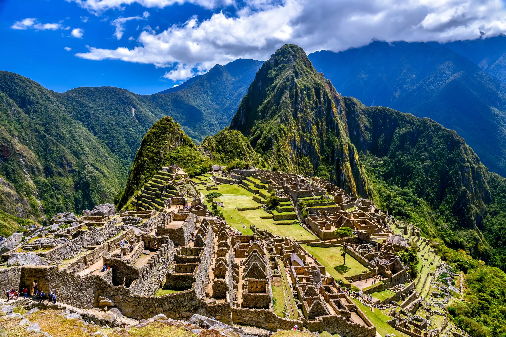 View of Machu Picchu under a blue sky, Peru.