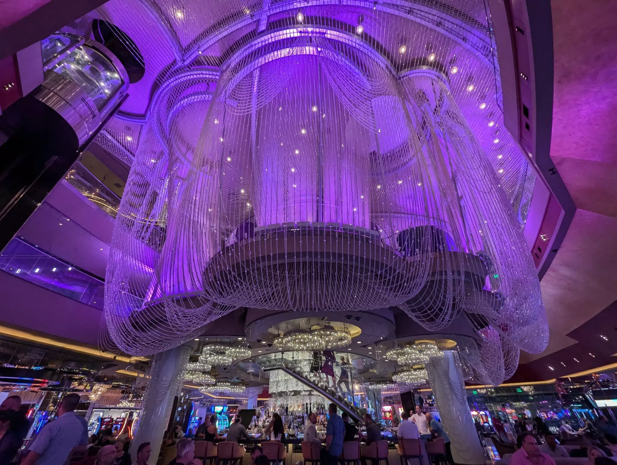 The Chandelier Bar at the Cosmopolitan Hotel in Las Vegas is surrounded by a beaded curtain with lilac.