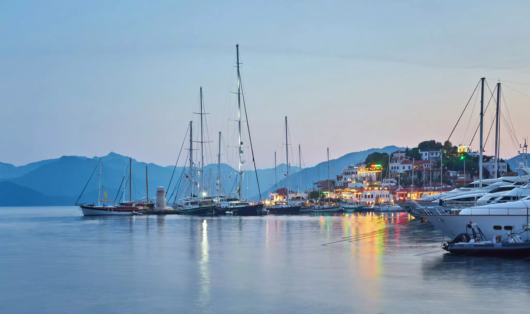 A marina with sailboats at dusk.