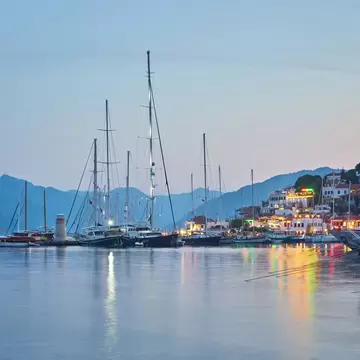 A marina with sailboats at dusk.