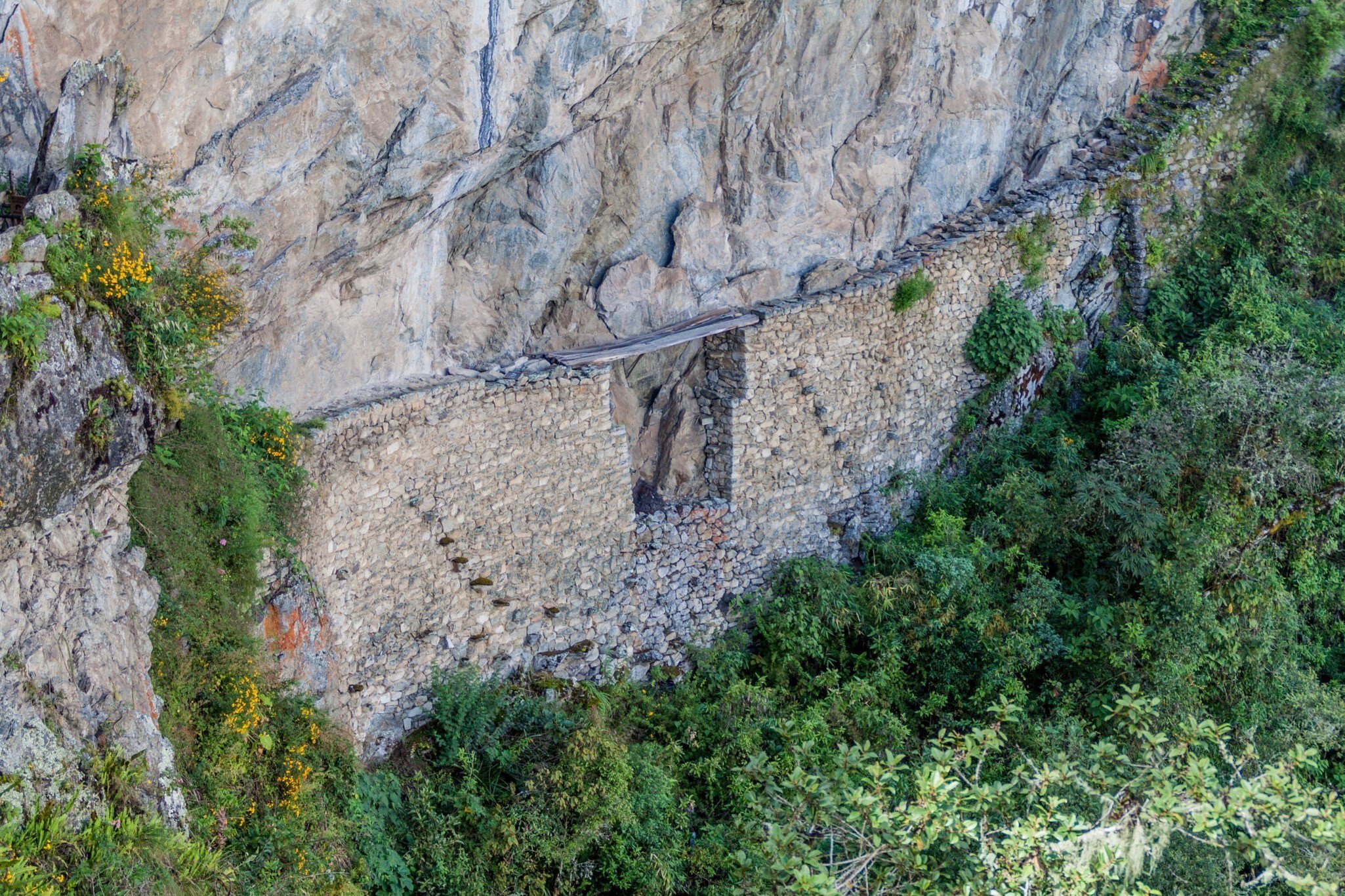 Inca Drawbridge carved into a stone wall near the Machu Picchu ruins, Peru.