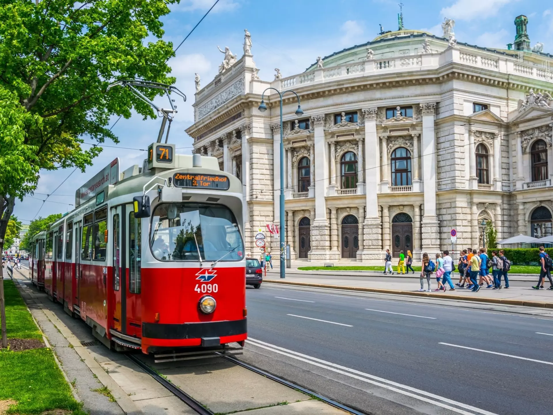 Wiener Ringstrasse with the historic Burgtheater (Imperial Court Theatre) and a traditional red electric tram.
567873295
architecture, attraction, austria, austrian, baroque, building, burgtheater, cable, capital, city, cityscape, classic, court, destination, hall, heritage, landmark, light, national, old, panoramic, public, rail, ring, ringstrasse, road, sightseeing, site, street, streetcar, summer, theater, theatre, tourism, tourist, touristic, town, track, train, tram, tramway, transport, travel, trees, unesco, urban, vacation, vienna, wien, world