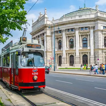 Wiener Ringstrasse with the historic Burgtheater (Imperial Court Theatre) and a traditional red electric tram.
567873295
architecture, attraction, austria, austrian, baroque, building, burgtheater, cable, capital, city, cityscape, classic, court, destination, hall, heritage, landmark, light, national, old, panoramic, public, rail, ring, ringstrasse, road, sightseeing, site, street, streetcar, summer, theater, theatre, tourism, tourist, touristic, town, track, train, tram, tramway, transport, travel, trees, unesco, urban, vacation, vienna, wien, world
