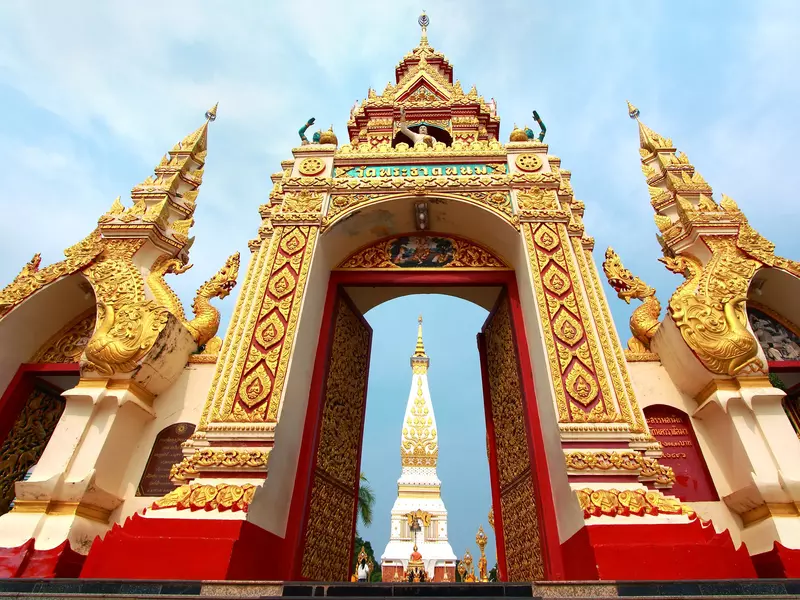 A gold-and-red ornate Thai-style stupa. 