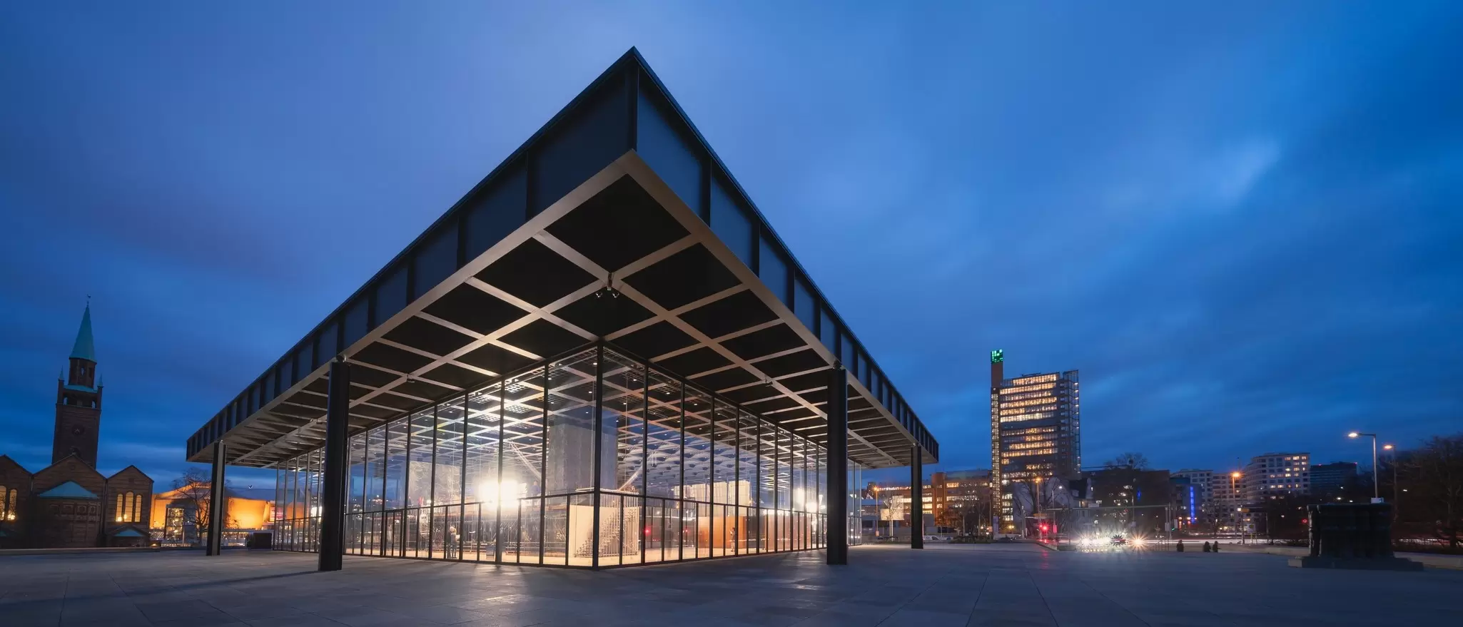 The Neue Nationalgalerie is illuminated at night in Berlin, Germany.