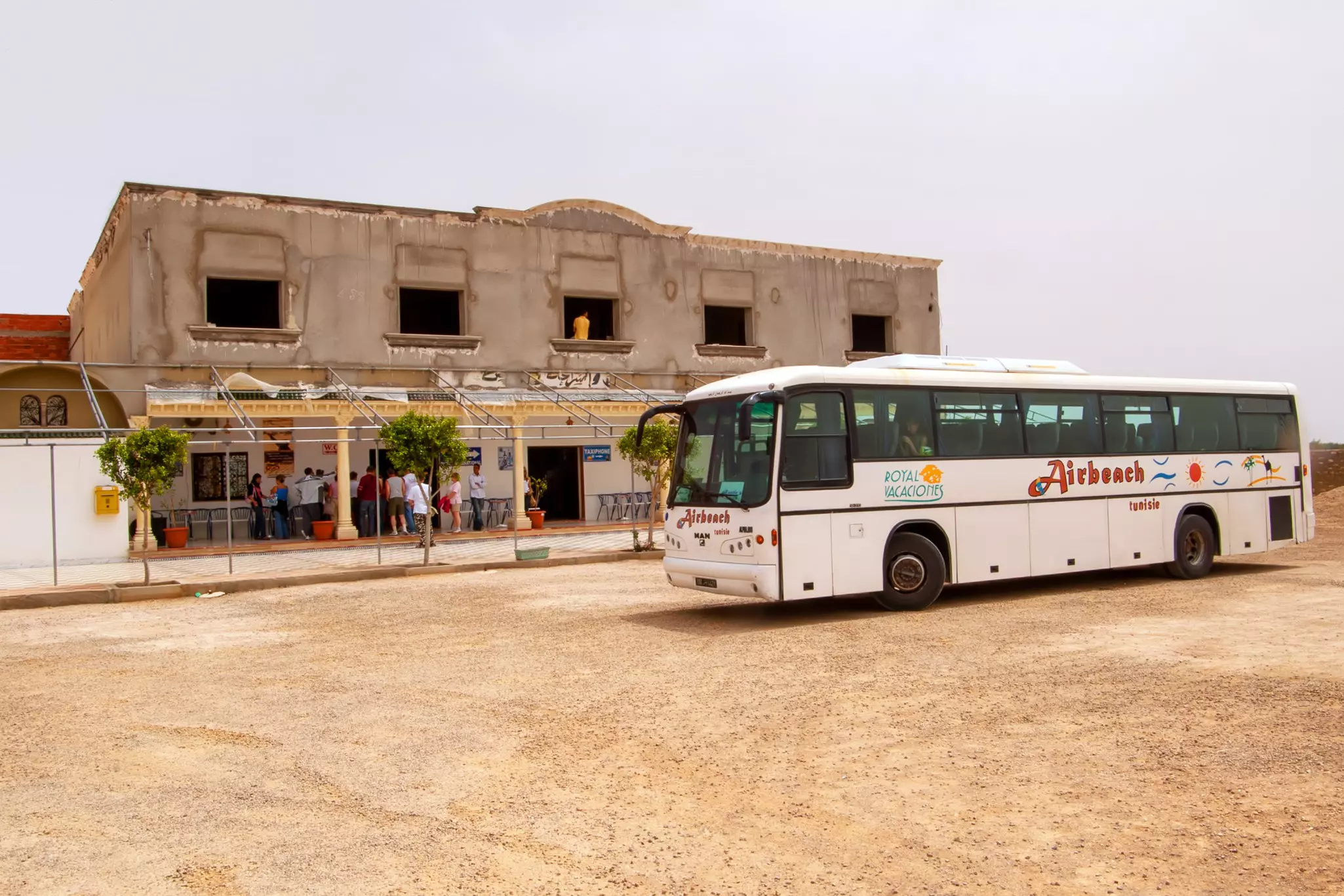 A tourist bus near a cafe in the Sahara desert, Tunisia.