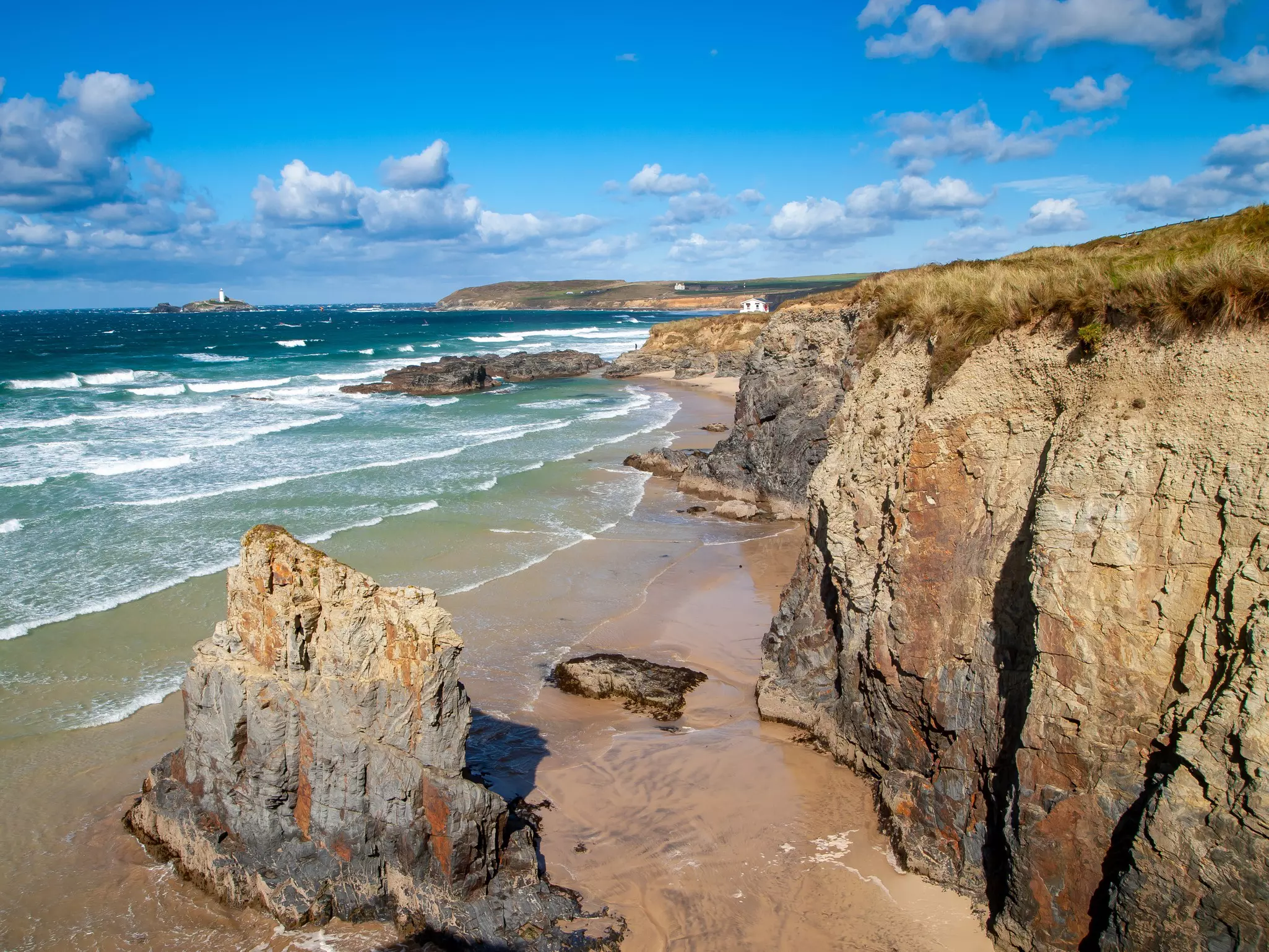 Beautiful golden sandy beaches along rocky coastal cliffs
