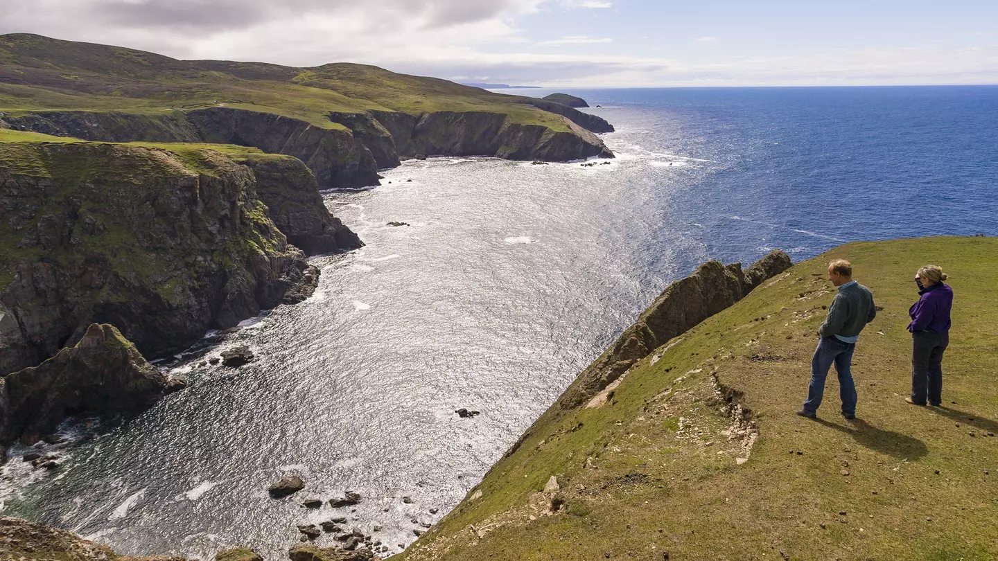  People look at cove, Atlantic coast, Aran Island.