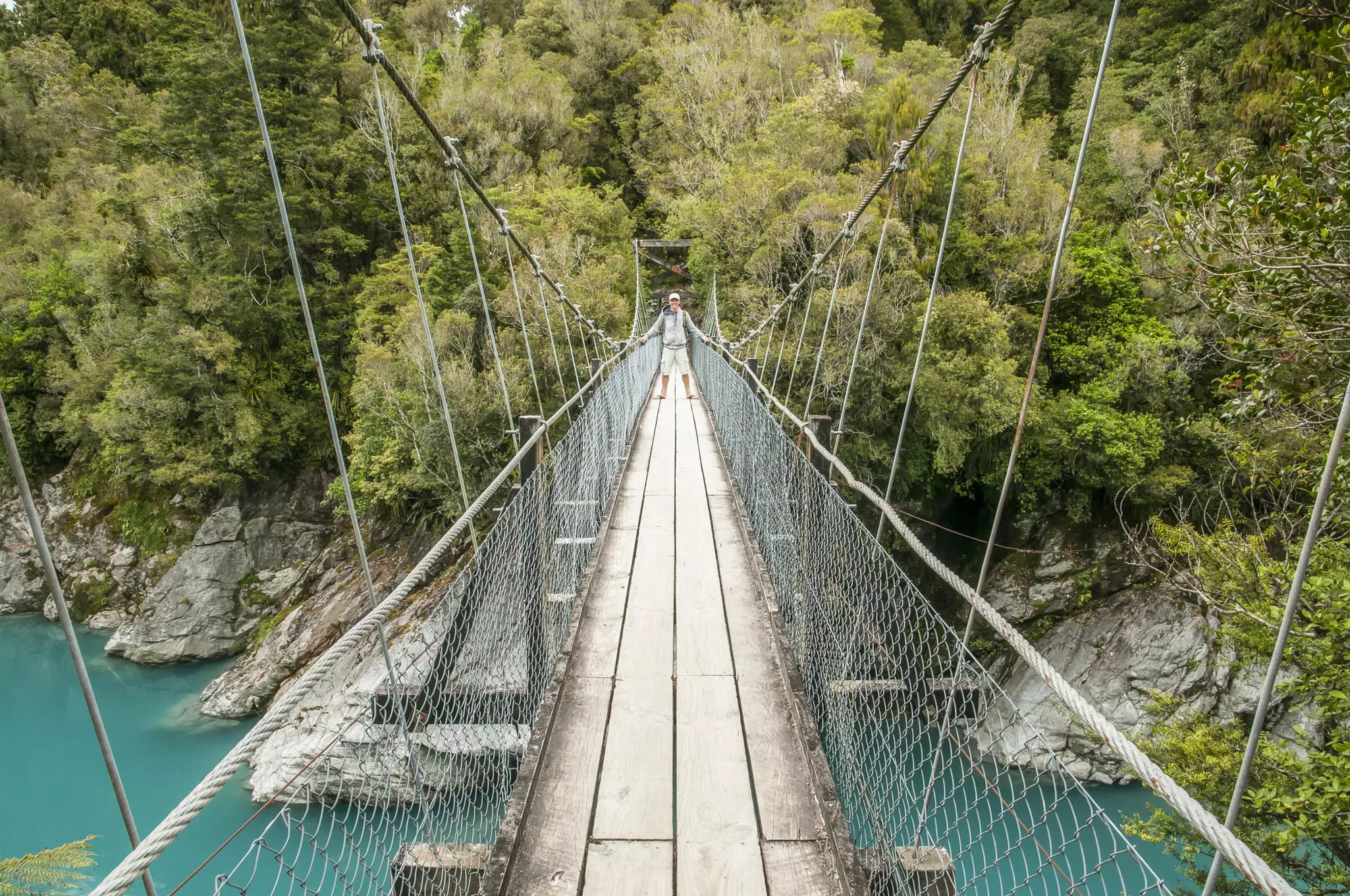 Tourist on a hanging bridge at Hokitika Gorge, West coast New Zealand