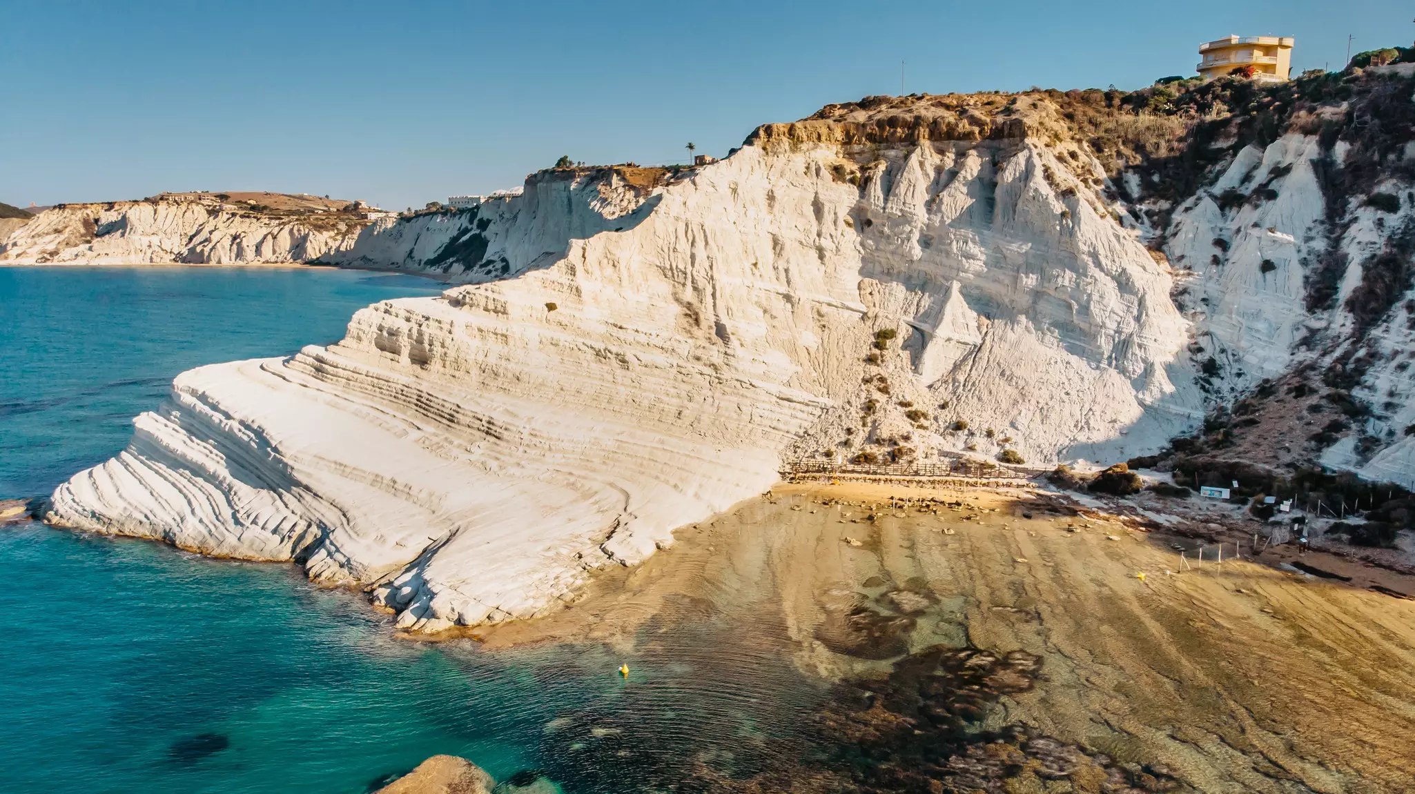 Scala dei Turchi, Sicily, Italy. Aerial view of white rocky cliffs, turquoise clear water.