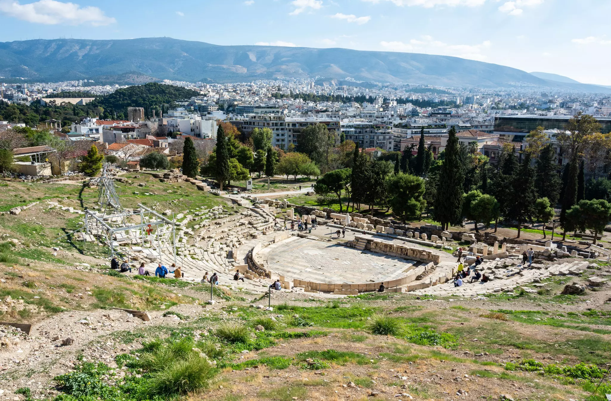View over the ruined Theatre of Dionysos in the Acropolis of Athens, with Athens in the background.