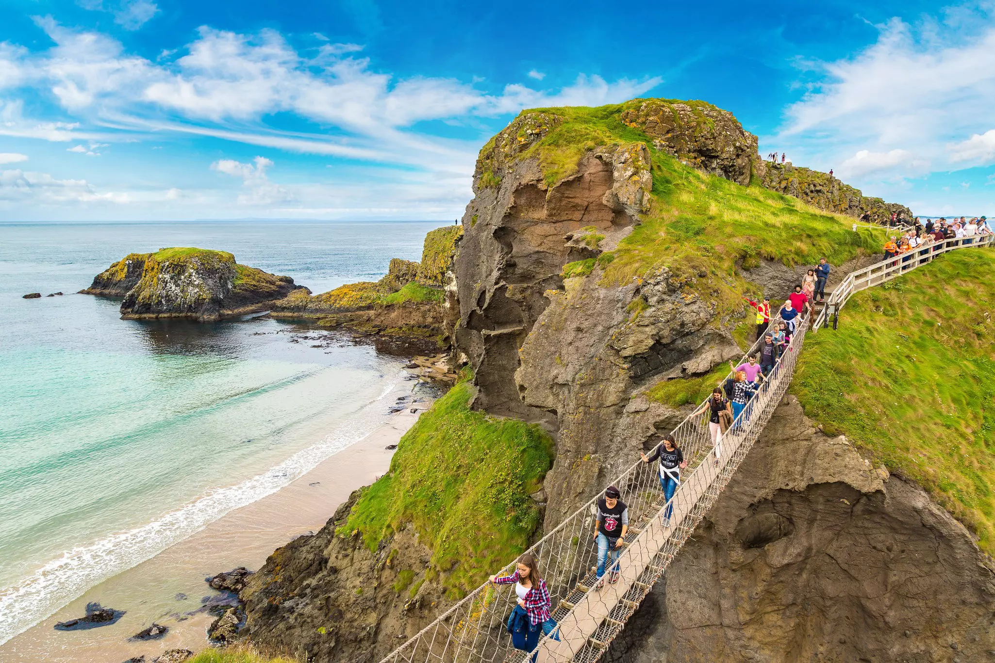 June 14, 2016: Visitors cross Carrick-A-Rede rope bridge in Northern Ireland.
583870759
antrim, atlantic, attraction, bridge, britain, carrick, carrickarade, carrick-a-rede, cliff, cloud, cloudy, coast, county, crossing, day, europe, european, grass, great, hiking, ireland, irish, island, kingdom, landmark, landscape, mountain, nature, northern, ocean, outdoor, people, rede, rock, rope, scenery, scenic, sea, shore, sky, steep, summer, tourism, tourist, travel, uk, united, view, walkway, water