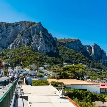 Capri, Italy - August 24 2020: Cityscape of Capri island with green hills and Monte Solaro mountain