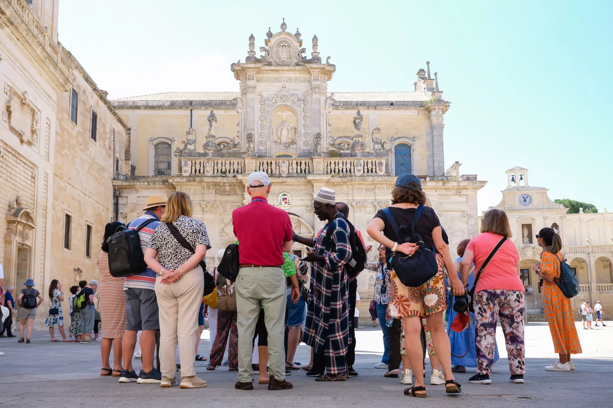 Lecce, Italy - June 8, 2023: African street vendor offers goods to tourists in Piazza Duomo., License Type: media, Download Time: 2026-05-21T16:58:11.000Z, User: lonelyplanetmedia, Editorial: true, purchase_order: 65050 - Digital Destinations and Articles, job: Comp Ingestion, client: Global Publishing WIP, other: Pia Peterson