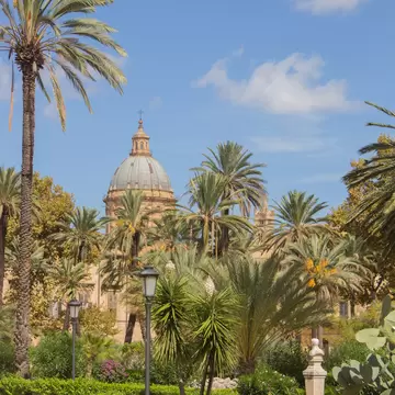 Botanical garden with a view of the Cathedral. Palermo, Sicily, Italy.