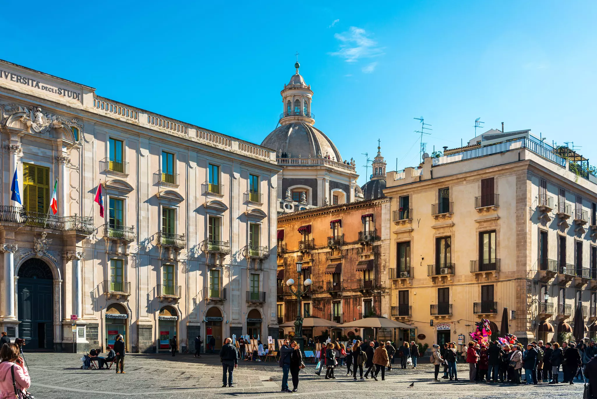 Tourists on foot Graben Street in Catania city, Italy