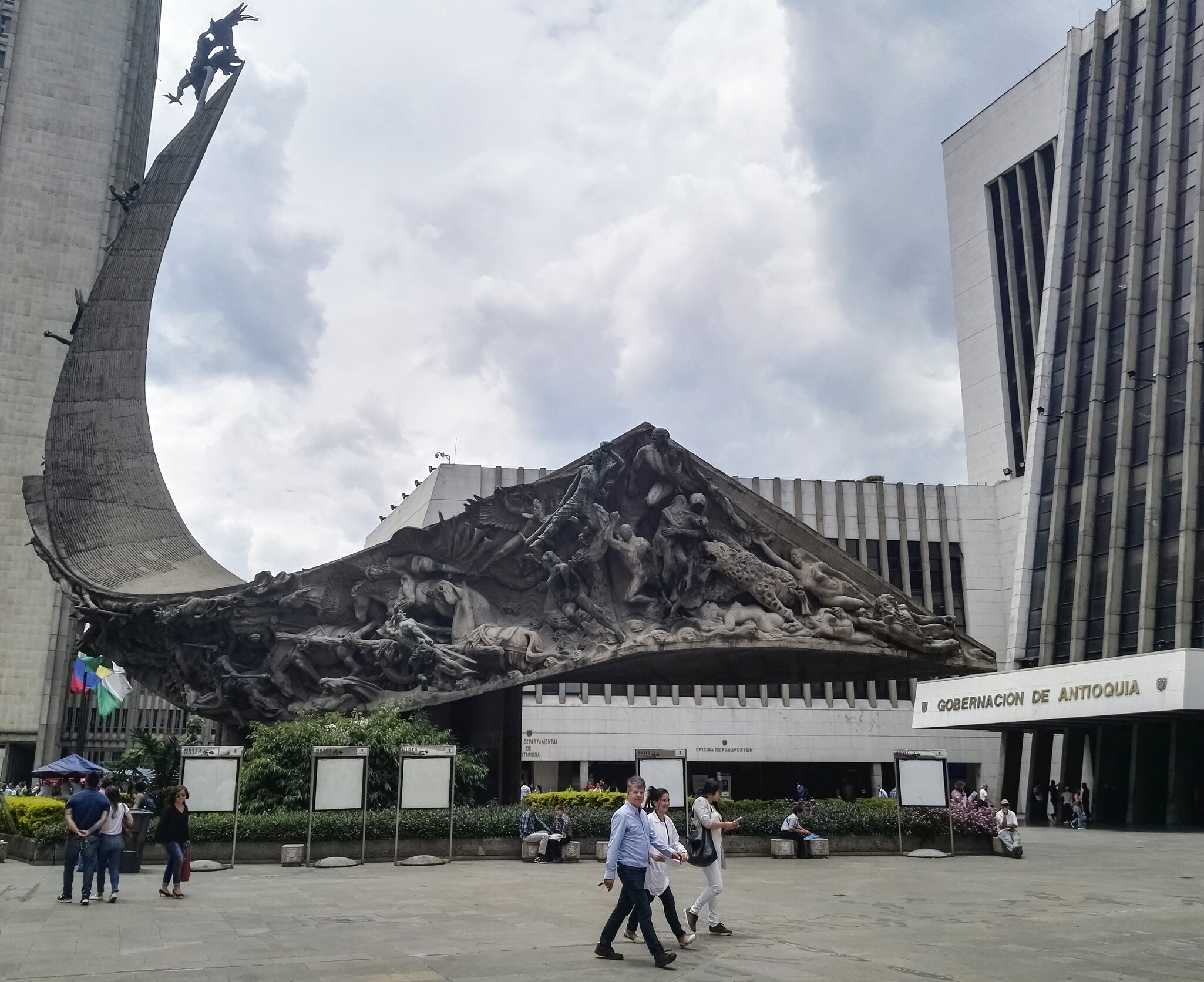 Monumento a la raza, raze monument, located in La Alpujarra, the public square of Medellin, Colombia, where the building of the Gobernacion de Antioquia (Antioquia management and government building) is located. Incidental people walking in the sq...