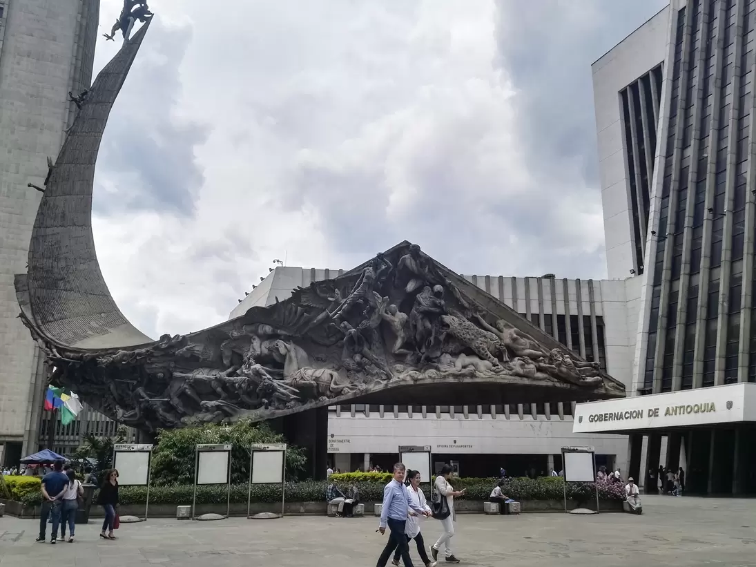 Monumento a la raza, raze monument, located in La Alpujarra, the public square of Medellin, Colombia, where the building of the Gobernacion de Antioquia (Antioquia management and government building) is located. Incidental people walking in the sq...