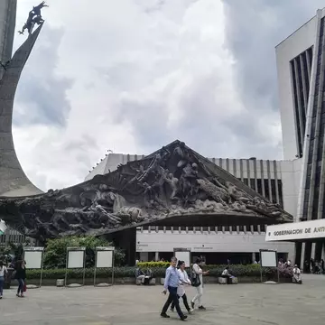 Monumento a la raza, raze monument, located in La Alpujarra, the public square of Medellin, Colombia, where the building of the Gobernacion de Antioquia (Antioquia management and government building) is located. Incidental people walking in the sq...