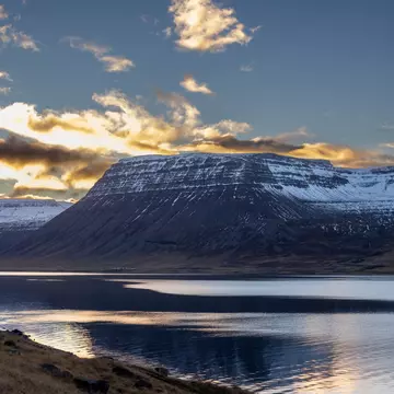 Mountains touched with snow. Colorful clouds on the blue sky during sunset Calm water of the Atlantic ocean in the fjord. Area of Westfjords, Isafjordur, Iceland., License Type: media, Download Time: 2025-11-24T19:05:45.000Z, User: comptonsheldon109, Editorial: false, purchase_order: 56530 - Guidebooks, job: Global Publishing WIP, client: Experience Iceland 2, other: Compton Sheldon