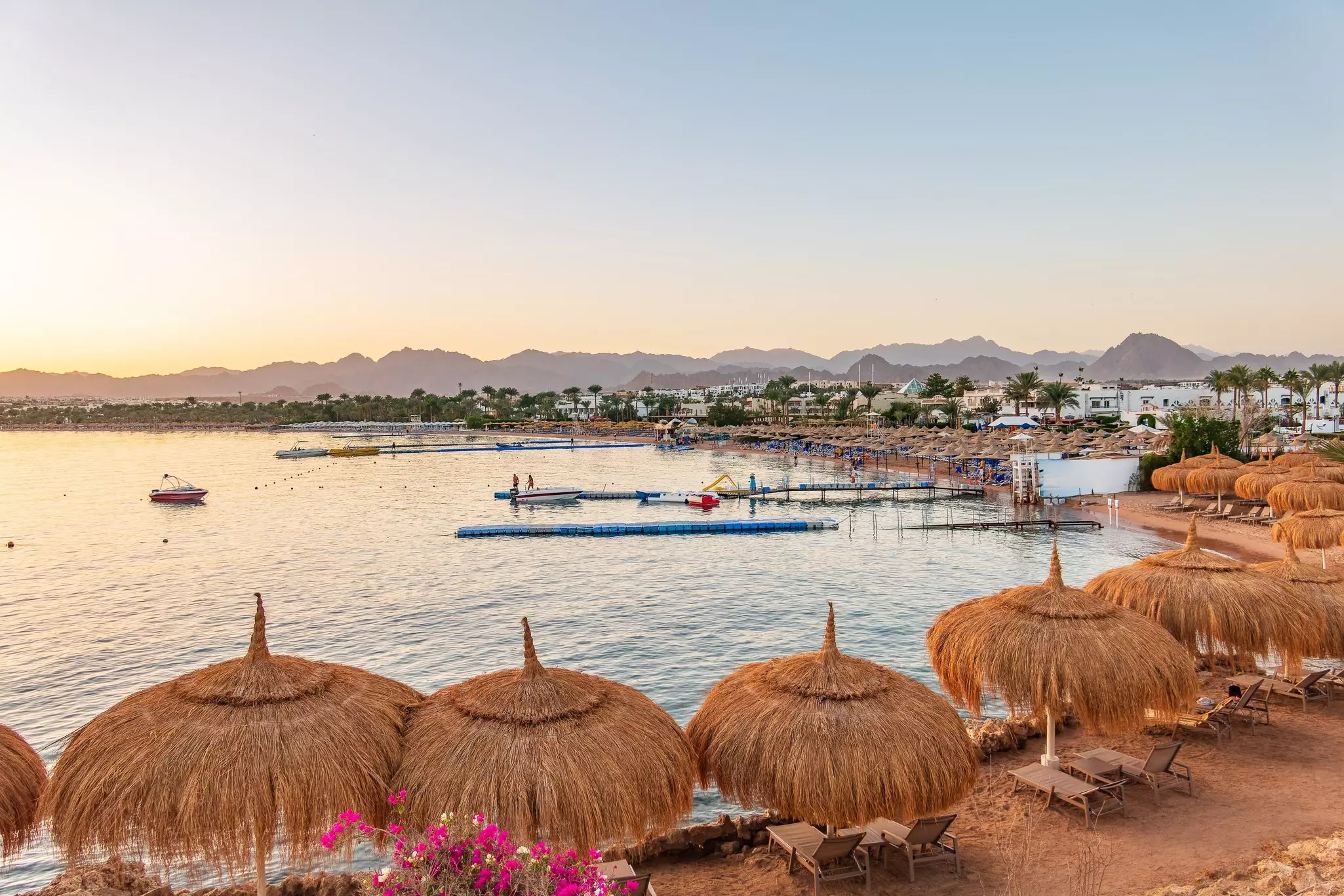 A line of grass sun umbrellas at Naama Bay, Sharm-el-Sheikh, Egypt.