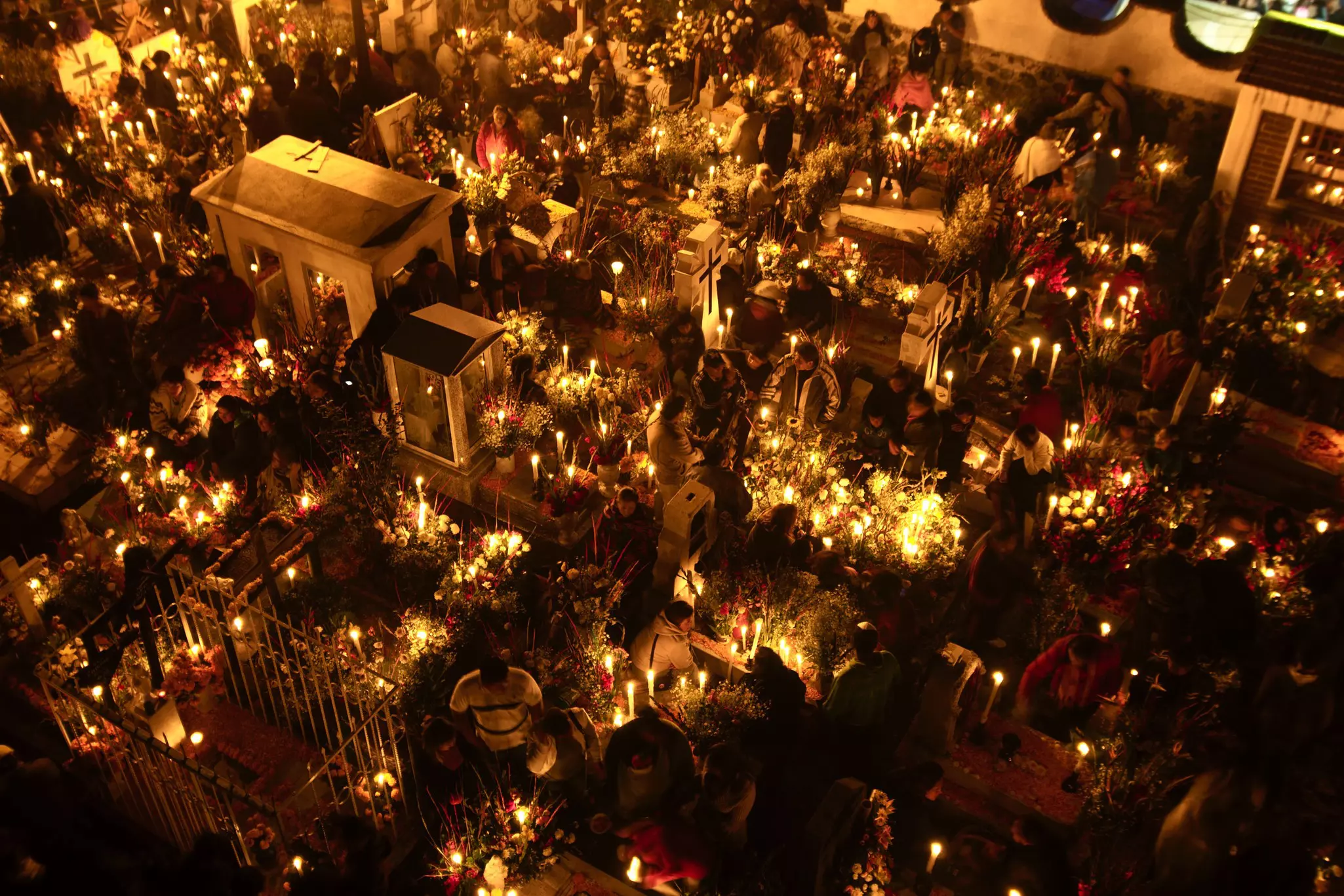 Candles illuminate the cemetery in San Andrés Mixquic near Mexico City during Día de Muertos.