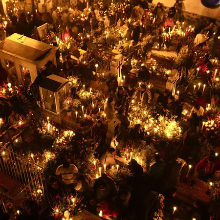 Aerial view of candles lit in a cemetery.