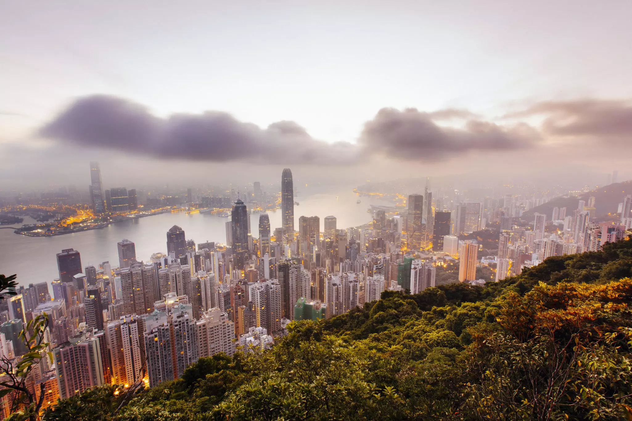 Hong Kong cityscape viewed from Victoria Peak beneath misty cloud.