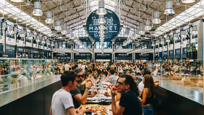 People dining inside a large covered food hall