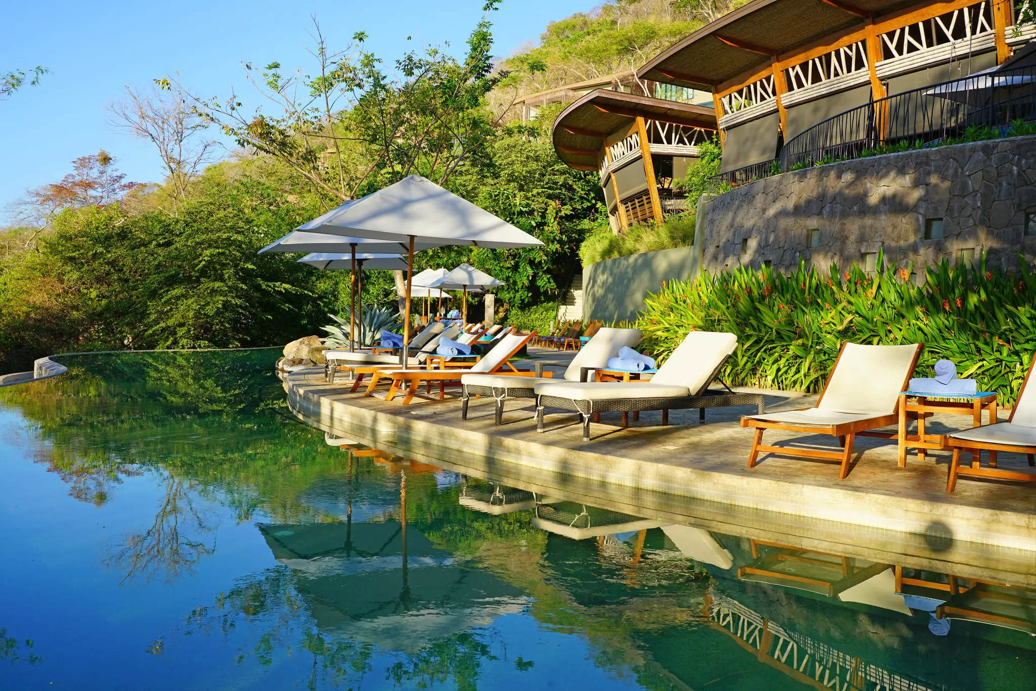 Lounge chairs by the water at Andaz Costa Rica Resort at Peninsula Papagayo